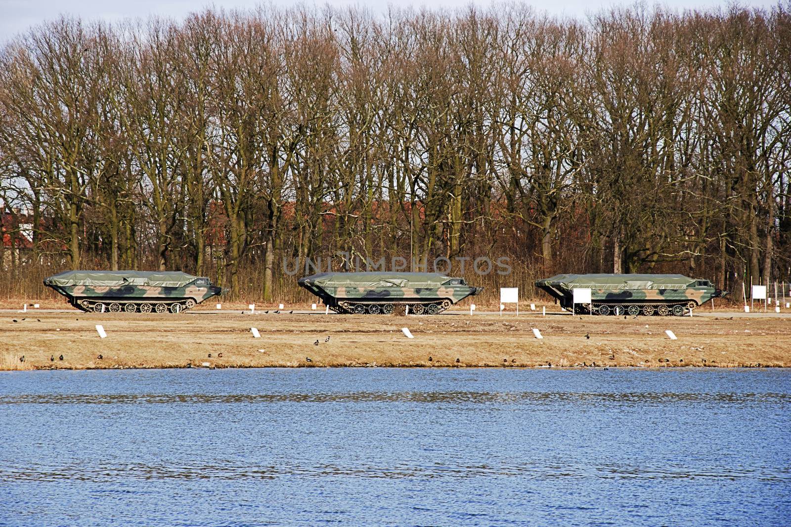 amphibious military car standing on a training ground near the river