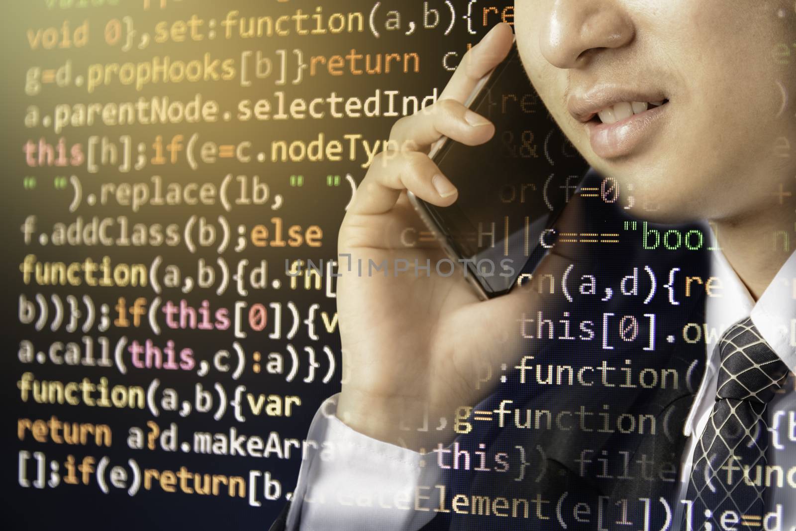 Businessman talking on cell phone, smartphone on computer code development background.