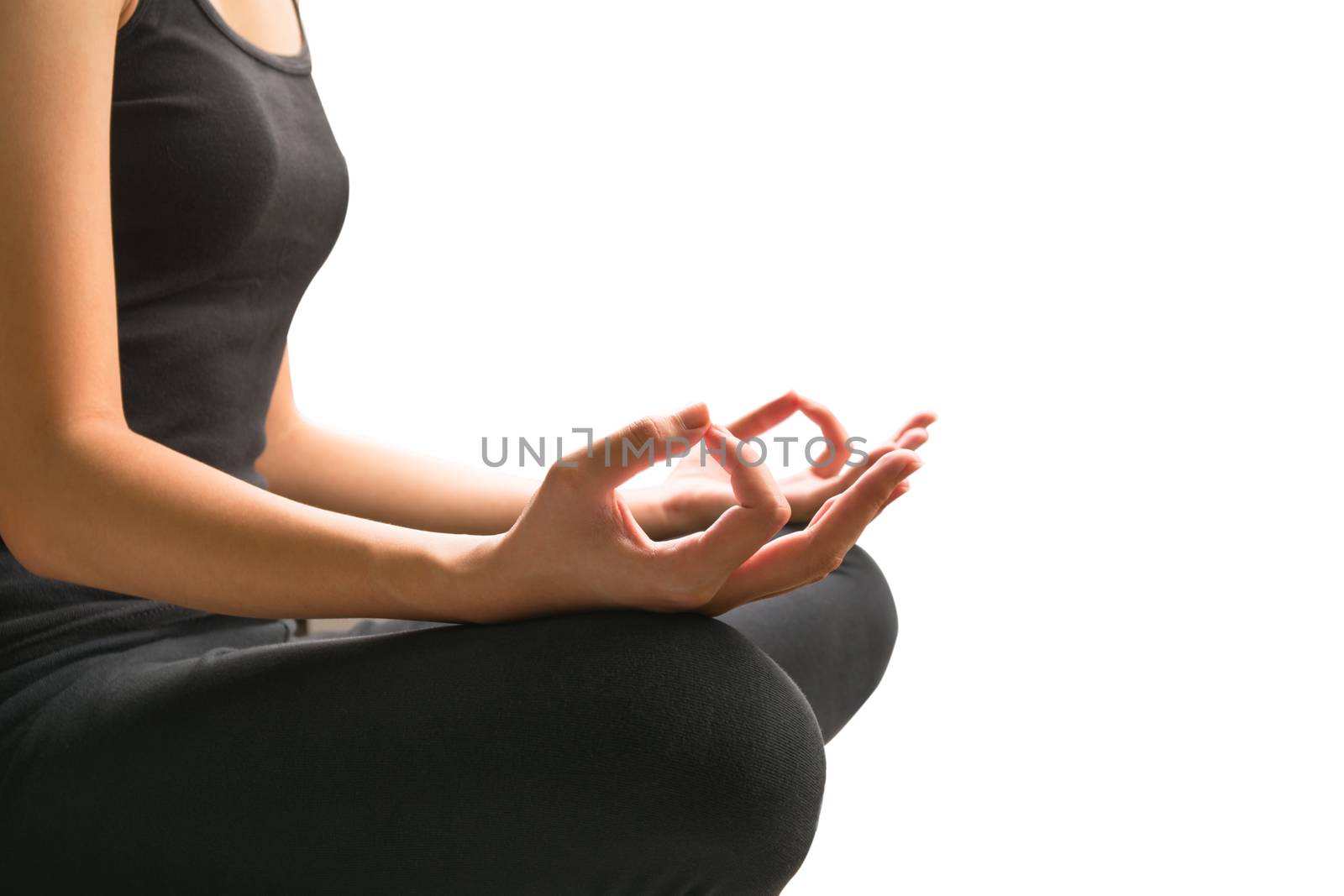 Close-up of feminine and masculine arms and crossed legs during meditation isolated on white background.