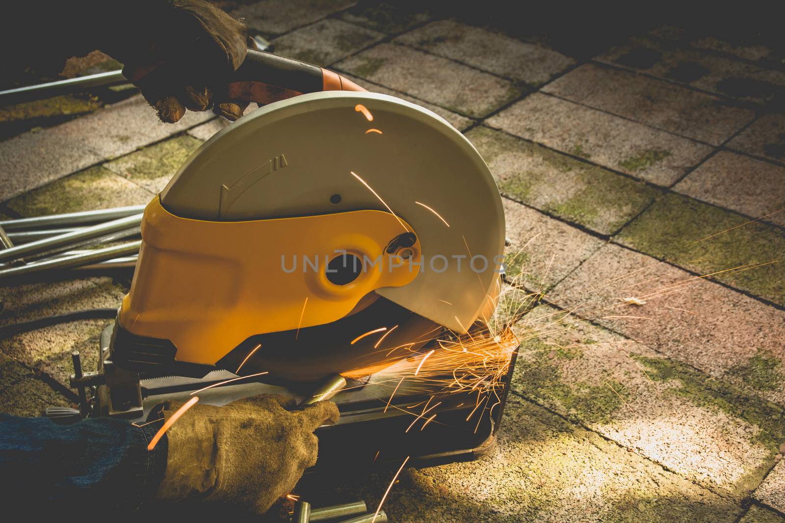 Industrial Worker at the factory steel cutting on the brick. by kirisa99