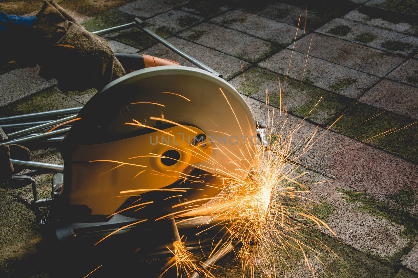 Industrial Worker at the factory steel cutting on the brick.