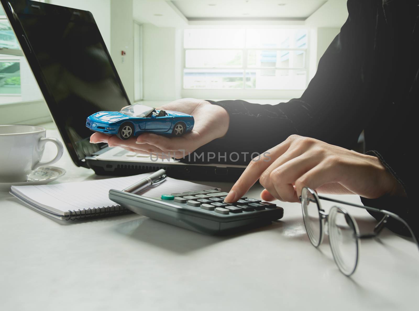 Car insurance and car services concept. Businessman with calculator and laptop.
