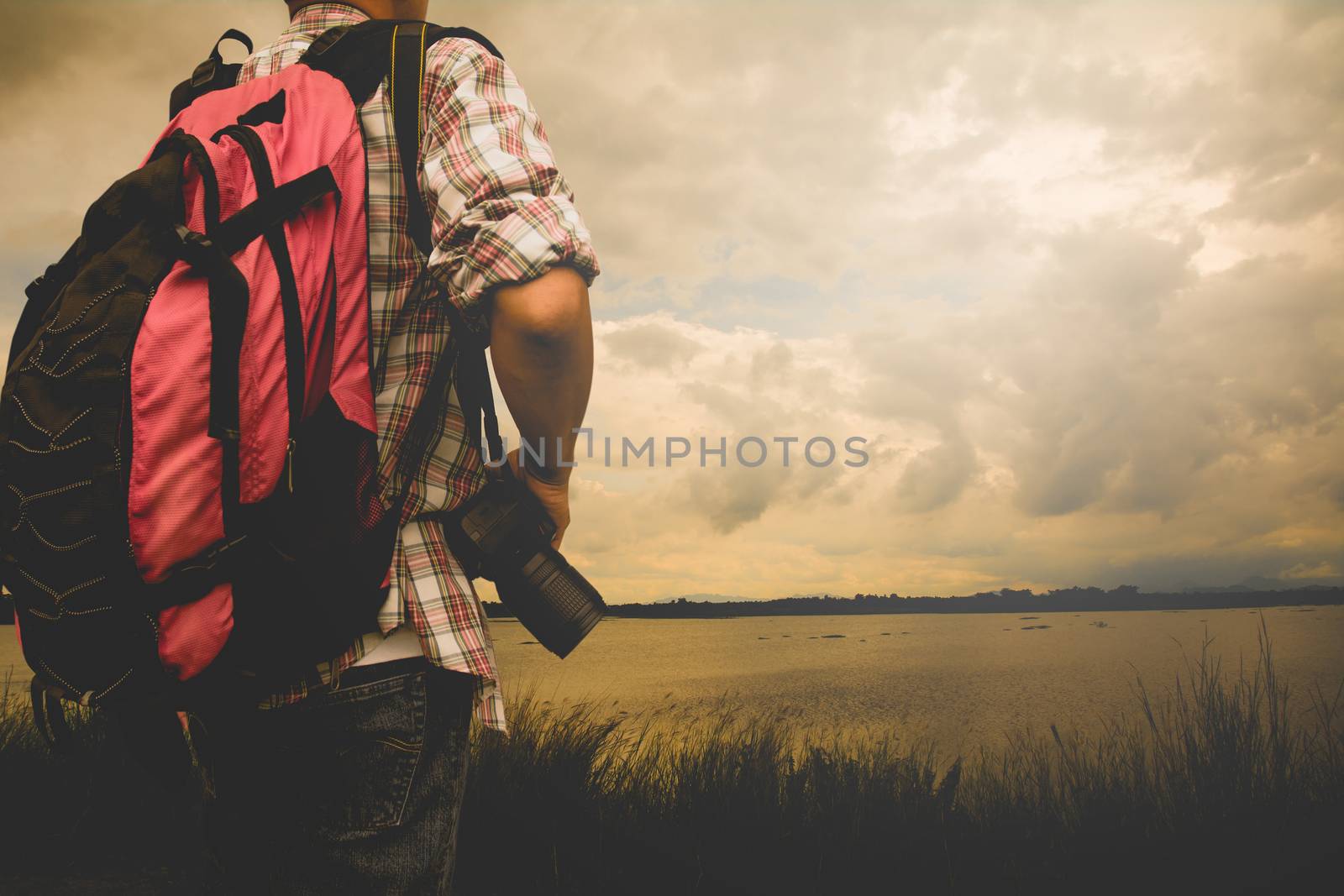 Traveler Man with red backpack and digital camera landscape on background Lifestyle travel success concept summer vacations outdoor