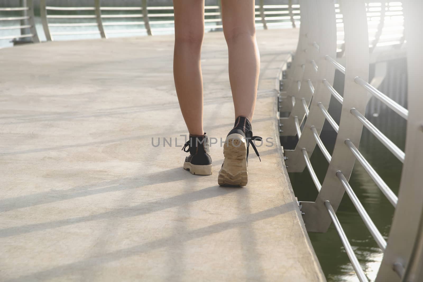 A young woman is walking.Walking women sneaker shoes.