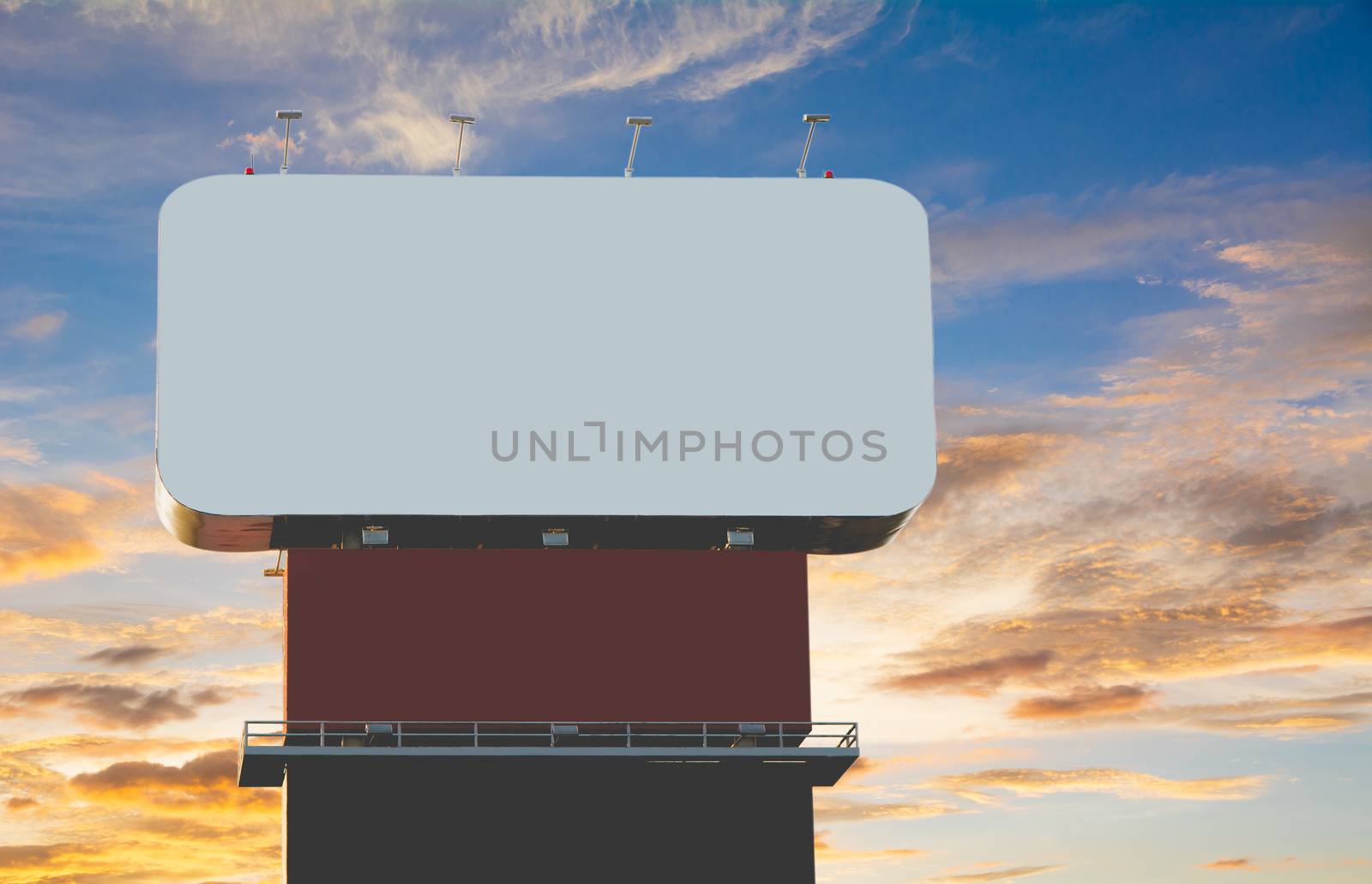 Blank billboard against under the blue with orange cloudy sky