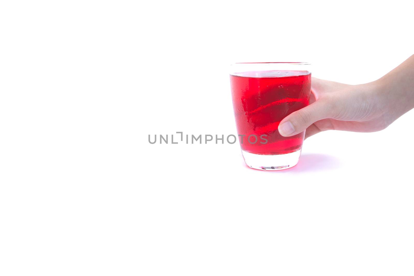 Hand holding a glass of syrup water isolated on white background