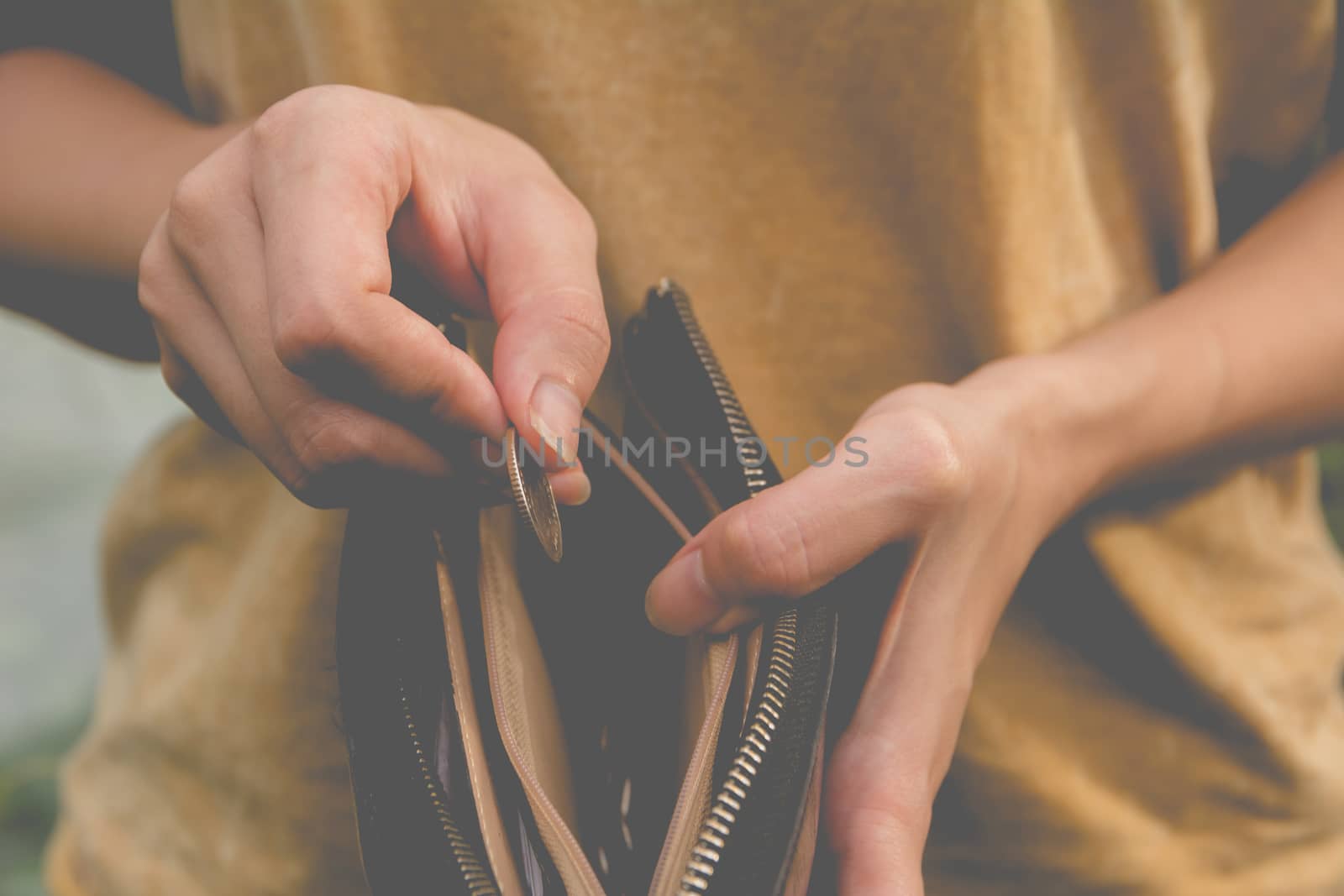 Close-up woman standing and holding money coin with wallet empty of money