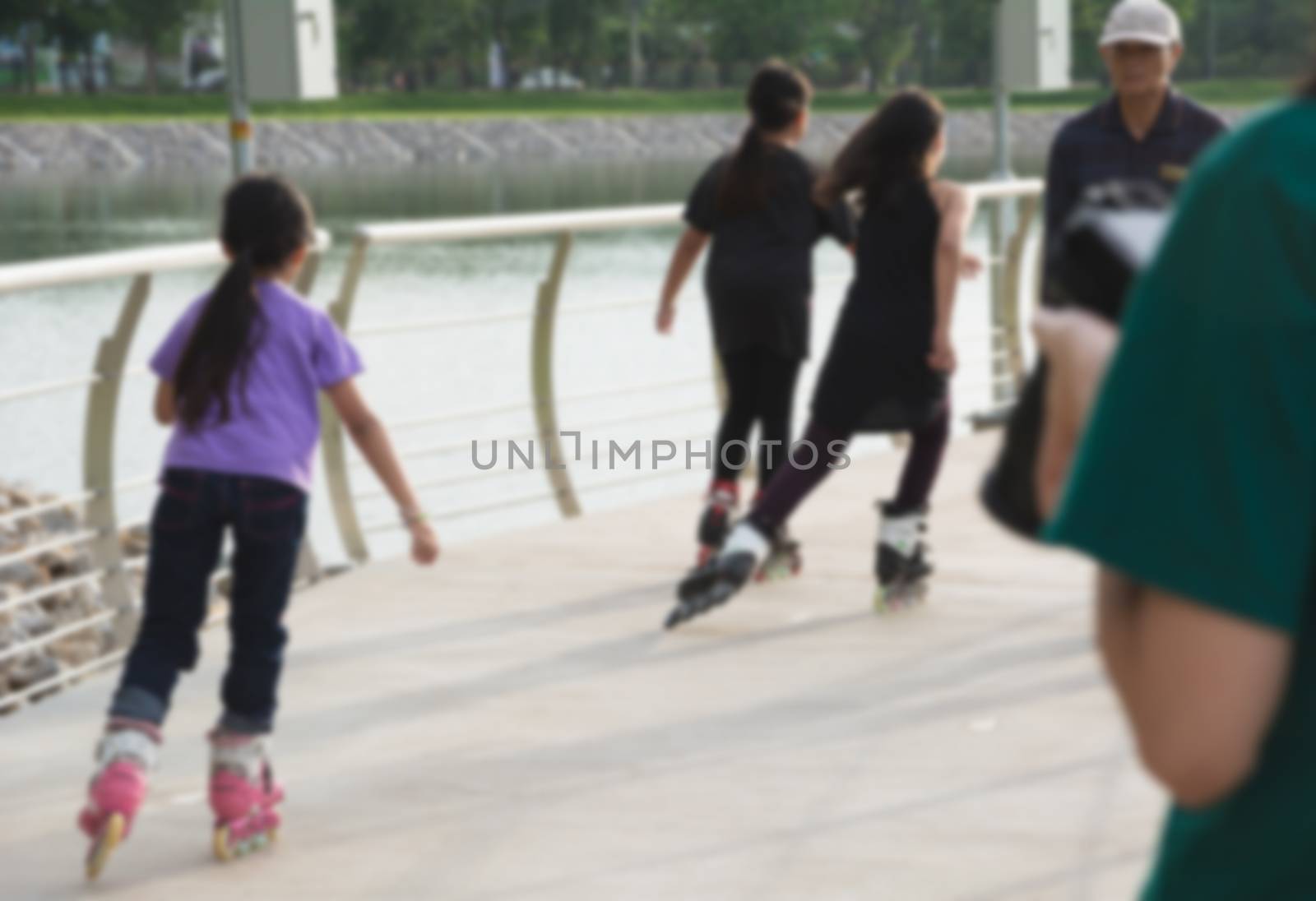 Blurred young people playing roller skates outdoor in park. Teen by kirisa99