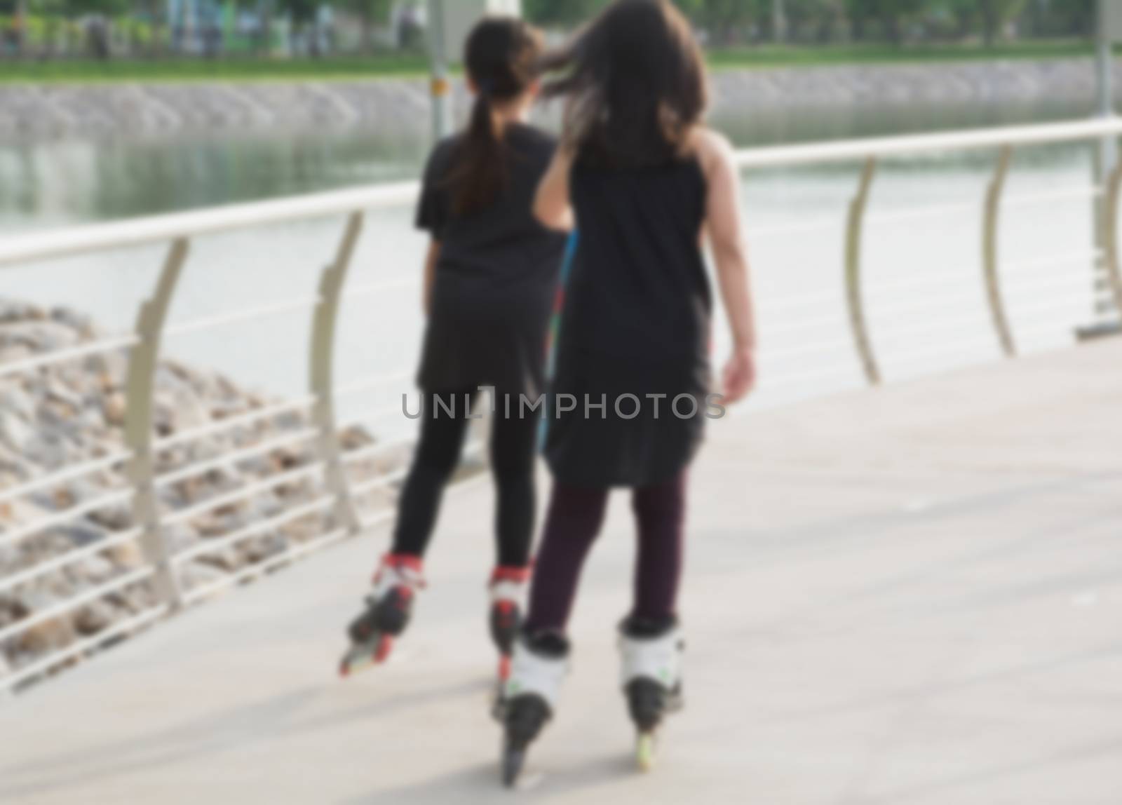 Blurred young people playing roller skates outdoor in park. Teen by kirisa99