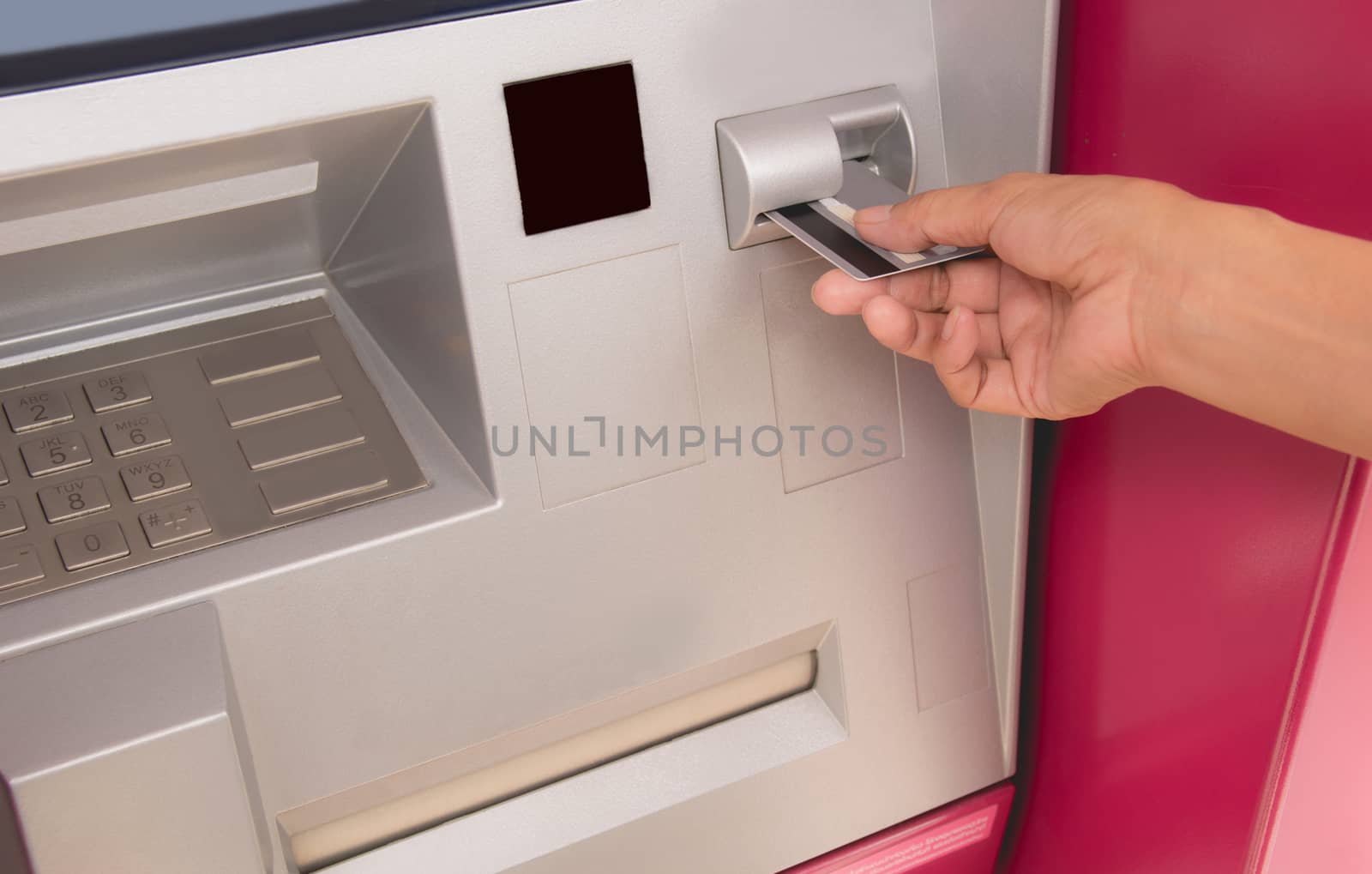 Hand of a woman with a credit card, using an ATM. Woman using an by kirisa99