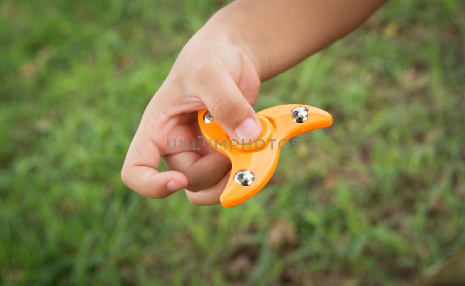 Children play with finger spinner gadget.Popular spinner device to play balance game.