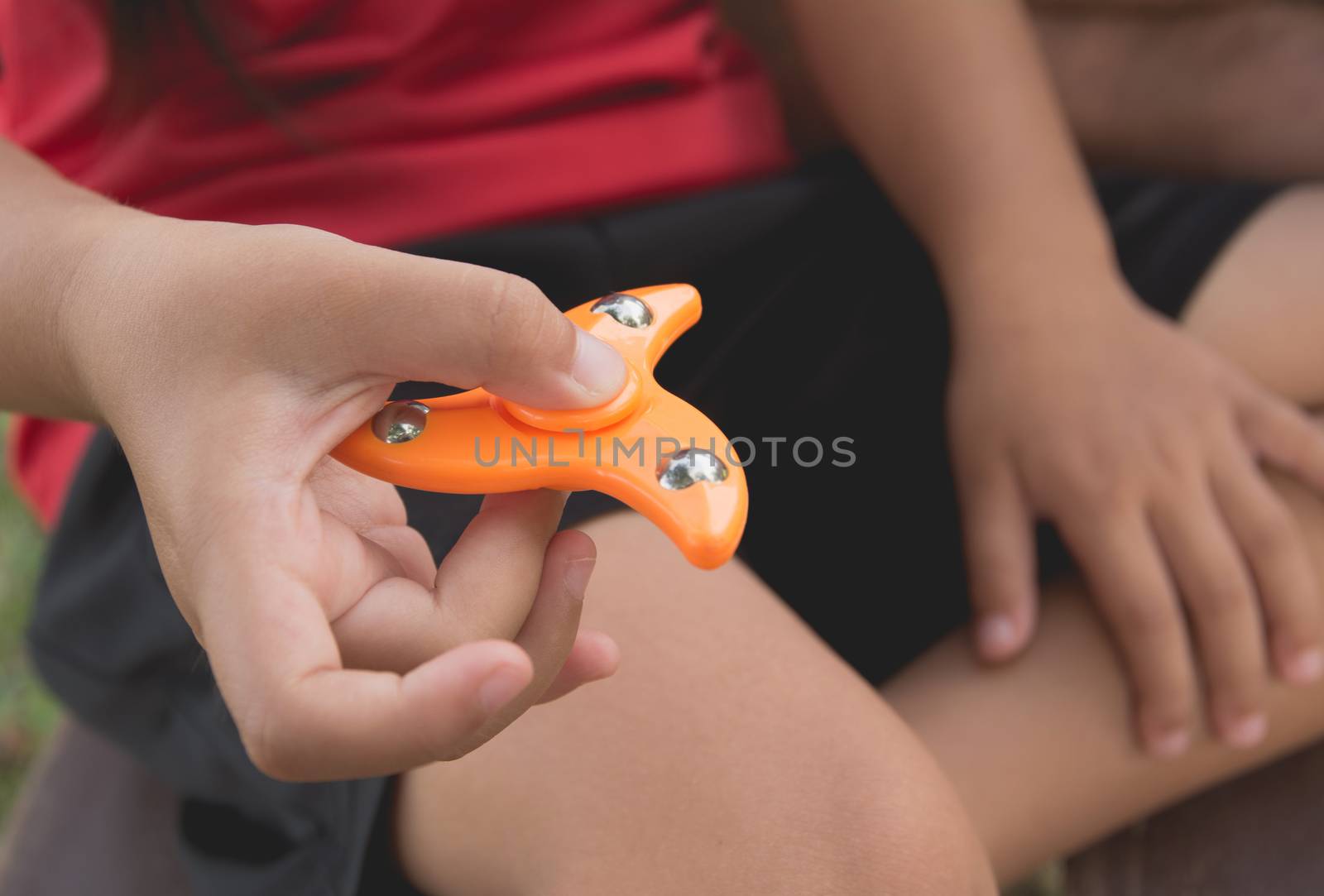 Children play with finger spinner gadget.Popular spinner device to play balance game.
