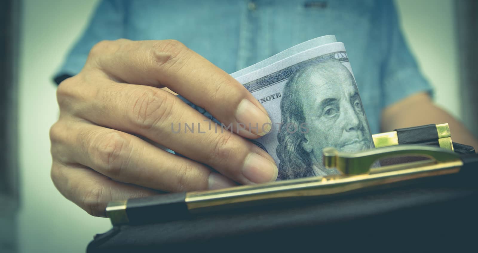 Male holding banknote in wallet in her hand for financial and sa by kirisa99