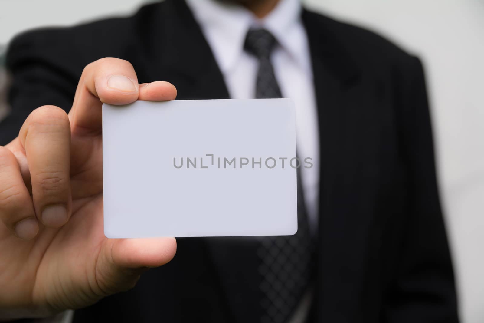 Hand of businessman holding the white card on white background.