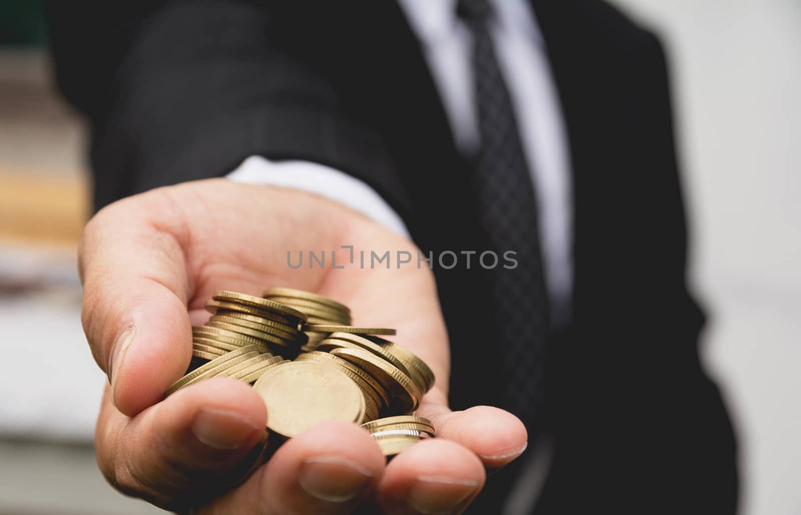 Businessman's hands have full of golden coins. Business financia by kirisa99