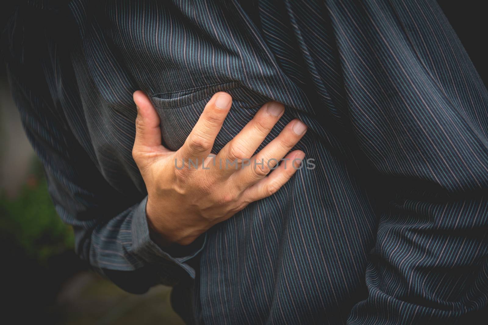 businessman having chest pain and heart attack, hand holding the by kirisa99
