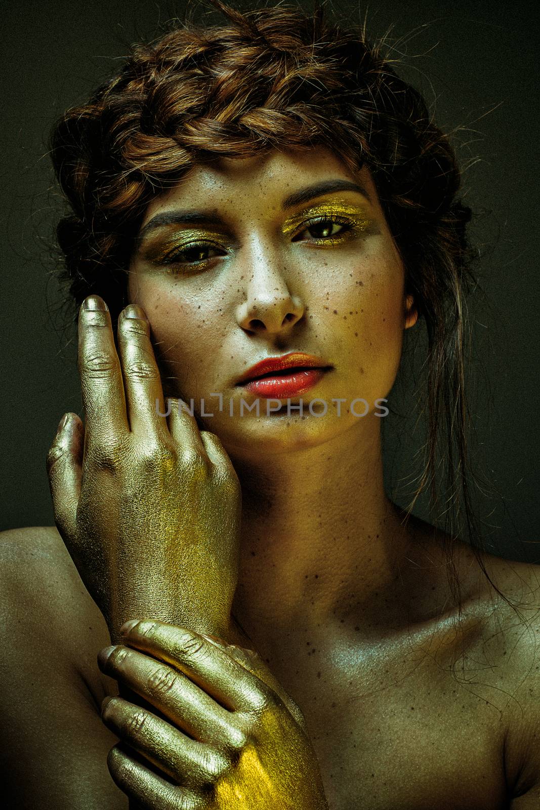 portrait extravagant and extreme gold makeup on cute girl face