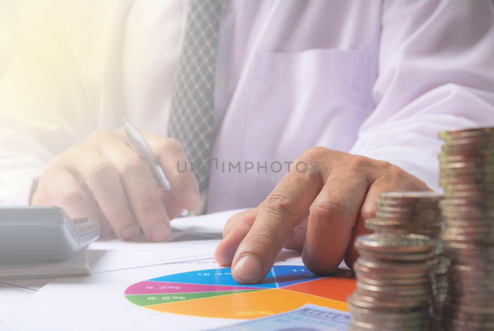 Businessman process with stack coins. Businessman working the project on table.