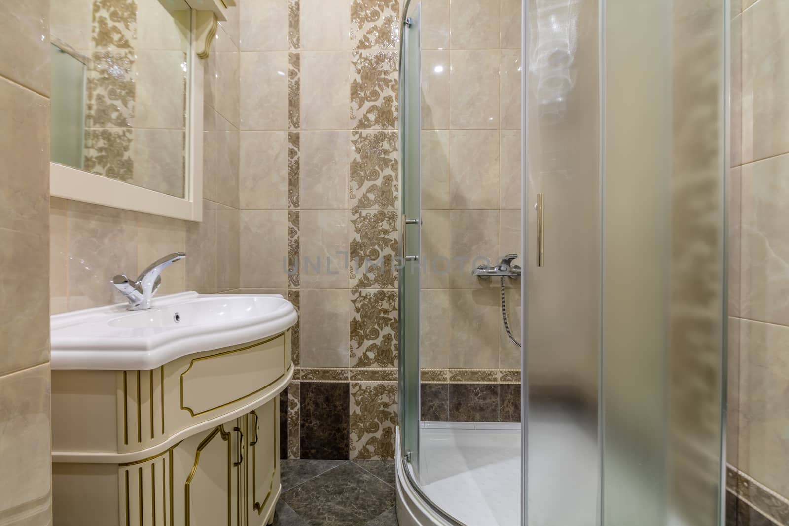Small beige tile bathroom with Shower cabin and sink