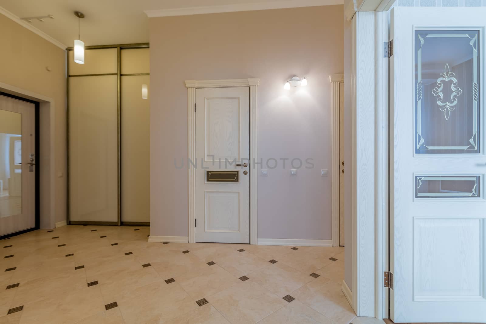 Empty bright entrance in modern apartment with mirror