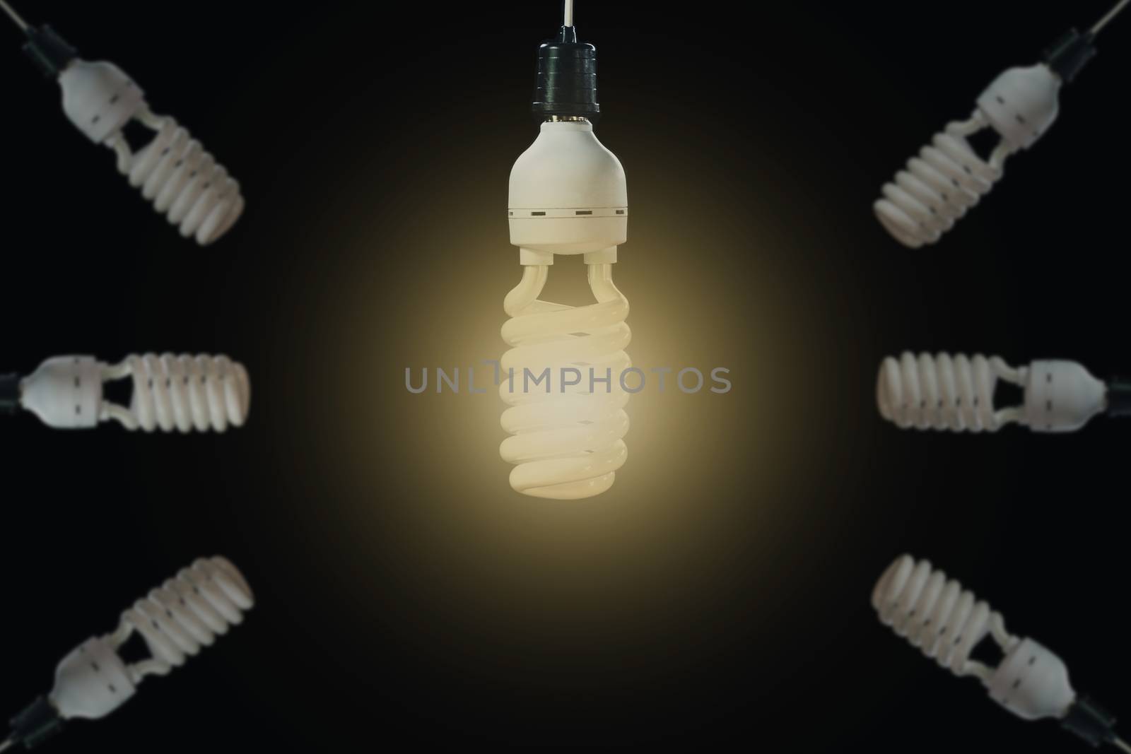 Hanging light bulbs with glowing one on dark background. Idea and creativity concept with light bulbs.