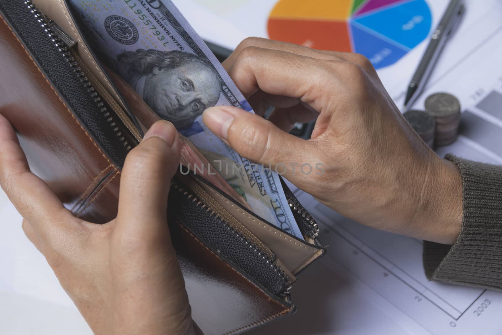 Businessman holding banknote in wallet in his hand for financial by kirisa99