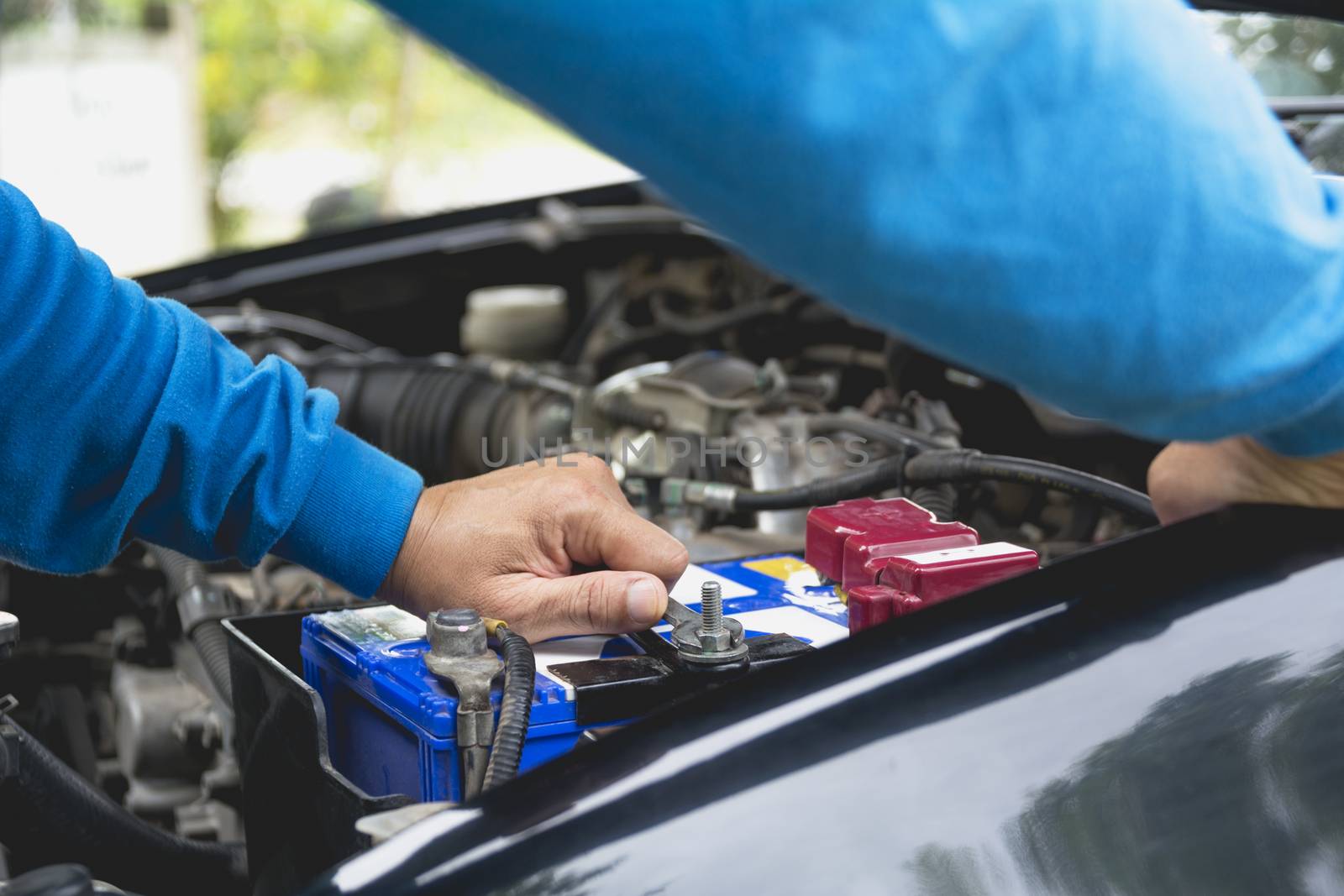 Hand of technician checking engine of car. Auto mechanic checking car engine. Maintenance checking car.