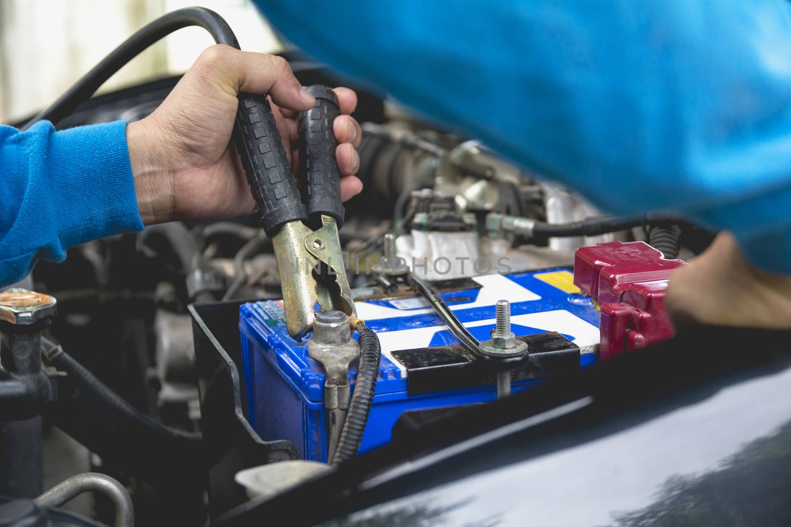 Hand of technician checking engine of car. Auto mechanic checkin by kirisa99