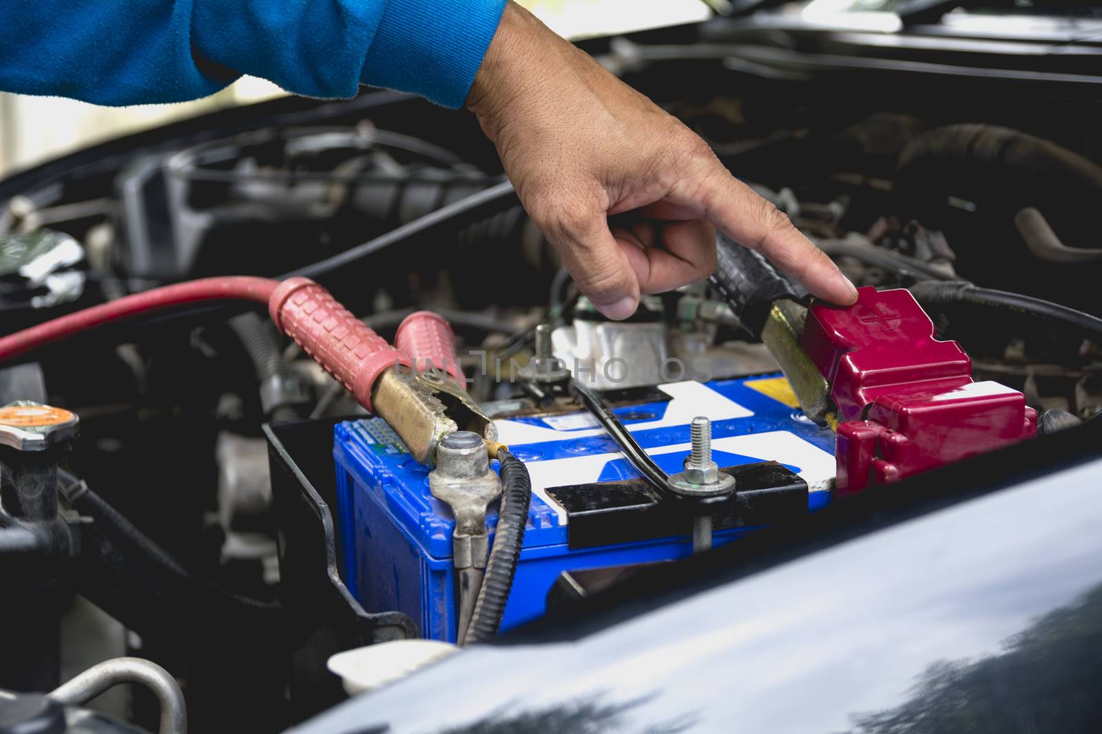 Hand of technician checking engine of car. Auto mechanic checkin by kirisa99