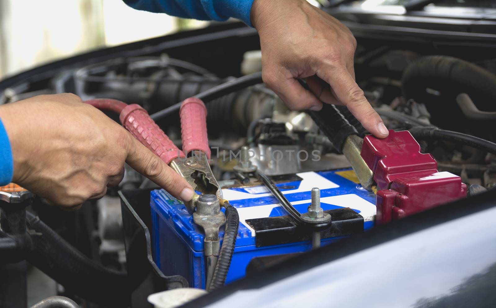 Hand of technician checking engine of car. Auto mechanic checking car engine. Maintenance checking car.