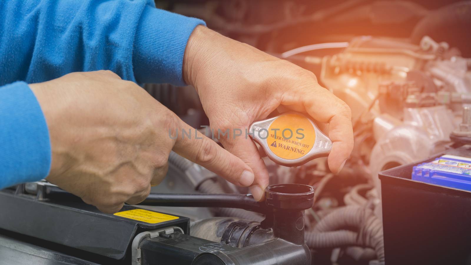 Hand of technician checking engine of car. Auto mechanic checking car engine. Maintenance checking car.