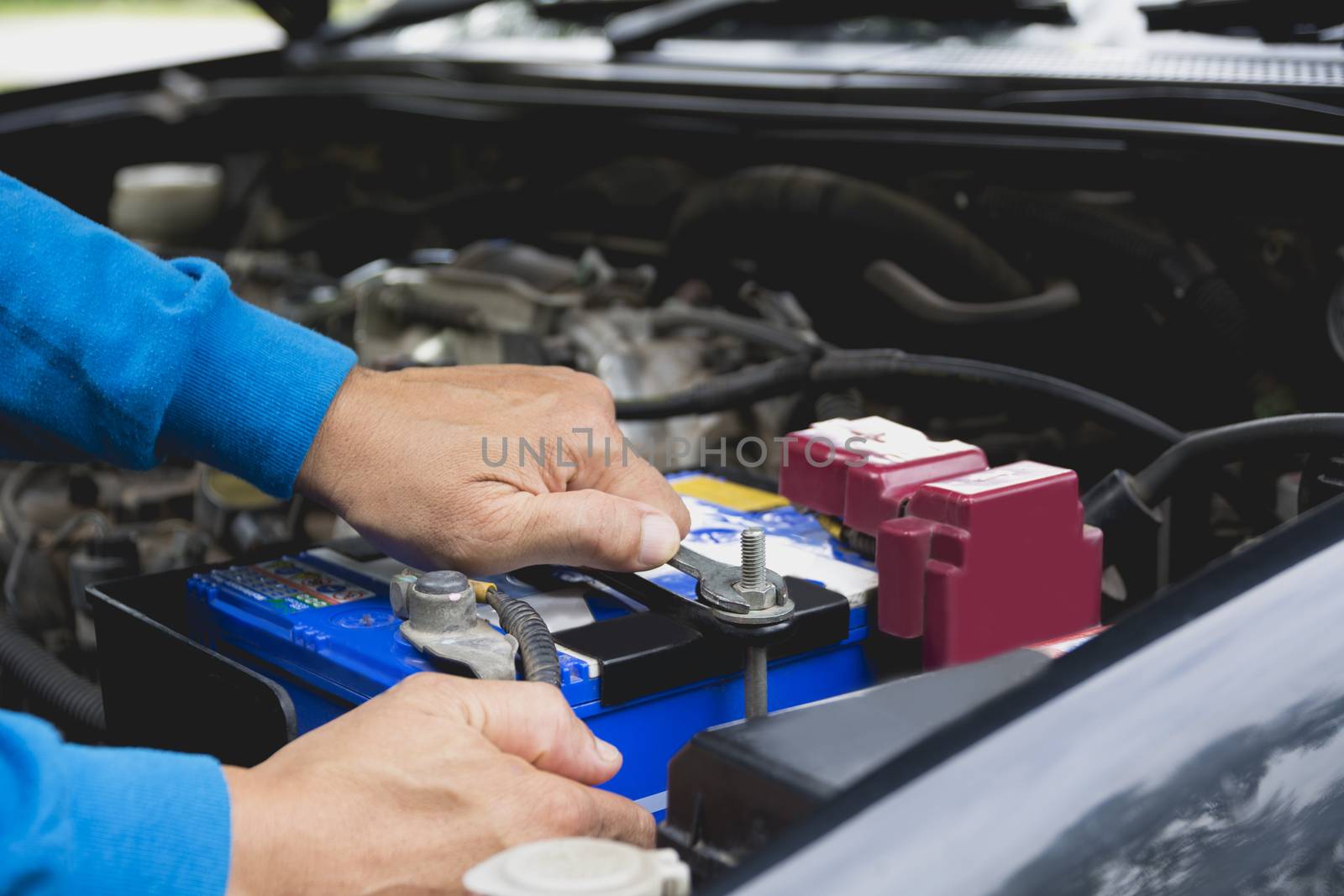 Hand of technician checking engine of car. Auto mechanic checkin by kirisa99