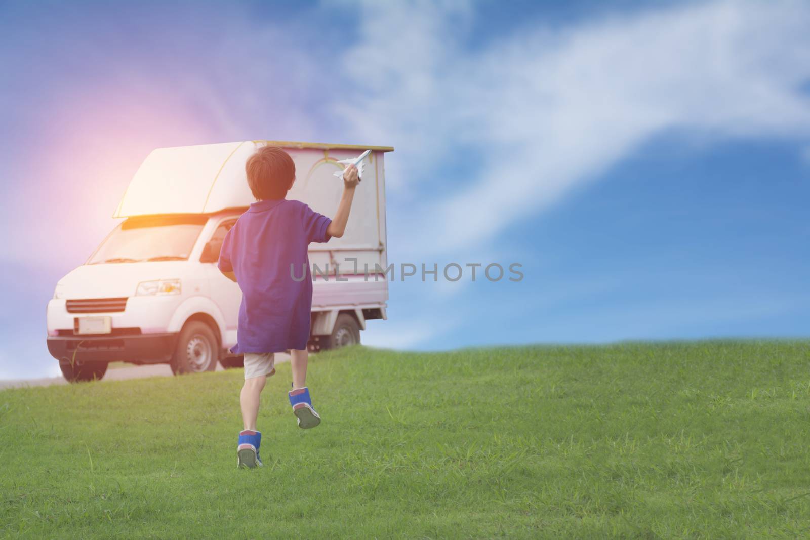 Kid playing with toy airplane and car. Kids playing with toy airplane at the day time. Kid having fun outdoors.