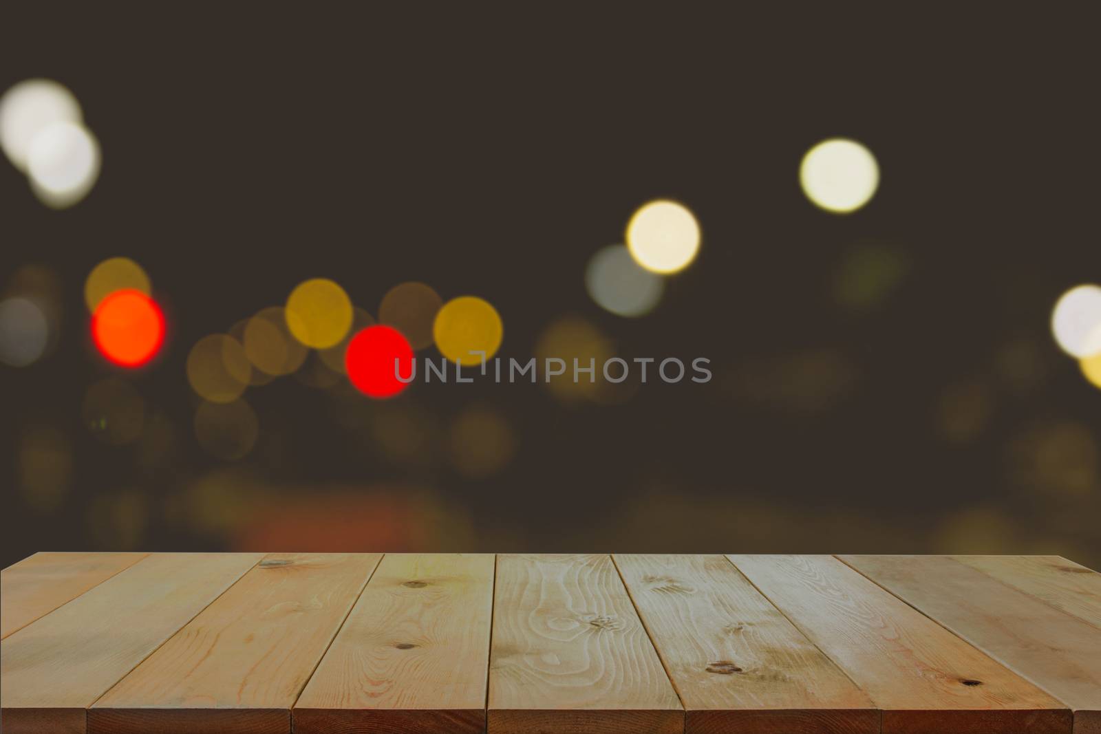 Empty wooden desk with blurred of light bokeh background.