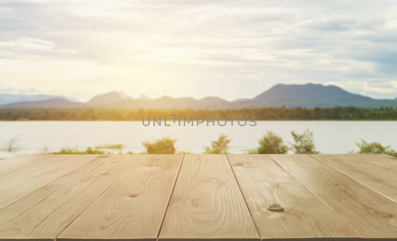 Empty wooden table with blurred natural abstract background. by kirisa99