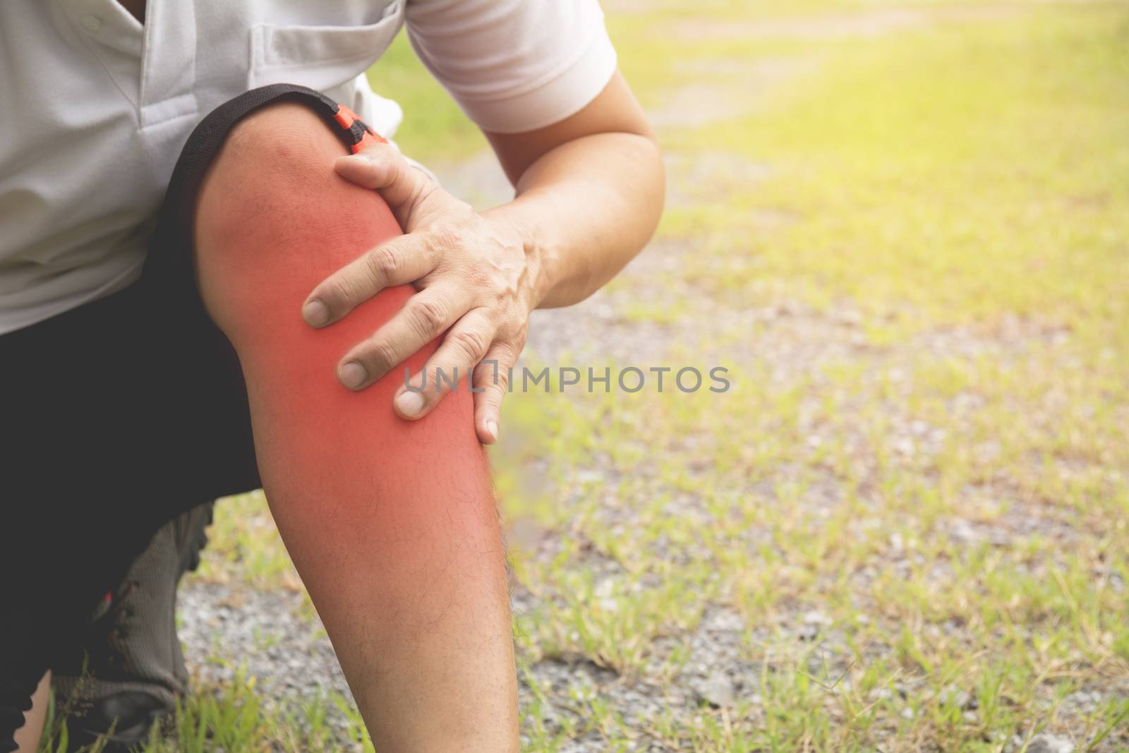 The guy clings to a bad leg. The pain in his leg after exercise. The pain is highlighted in red.