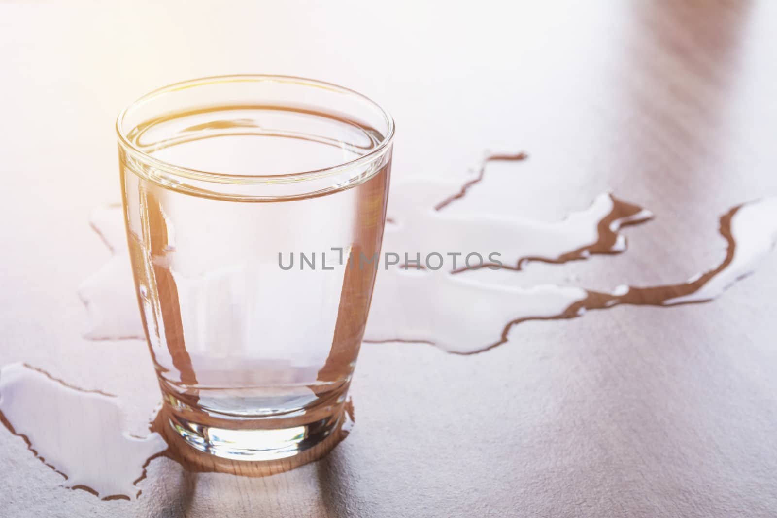 Water spill out of water glass and sloppy on wood table by kirisa99