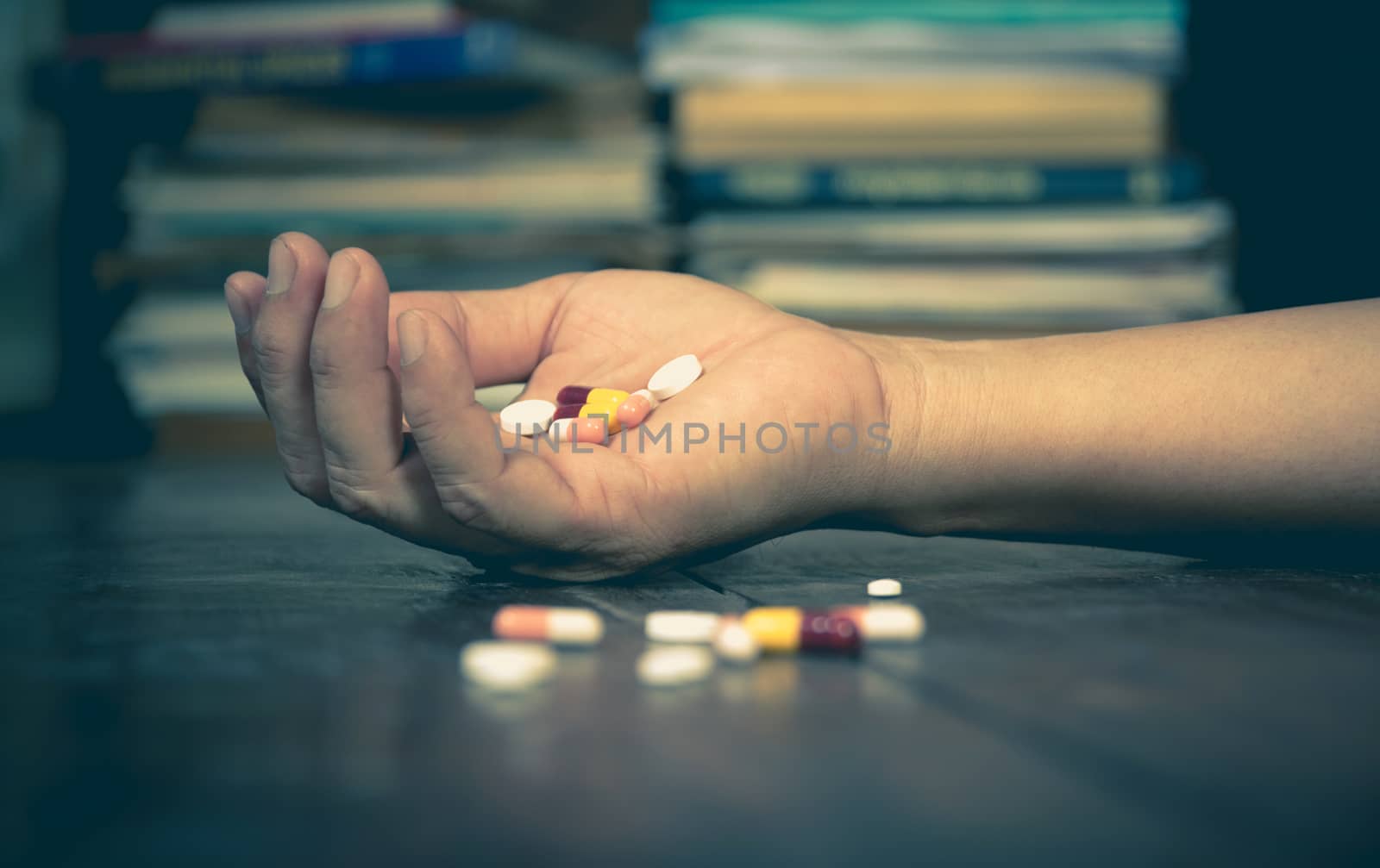 The man committing suicide by overdosing on medication. Close up of overdose pills and addict.