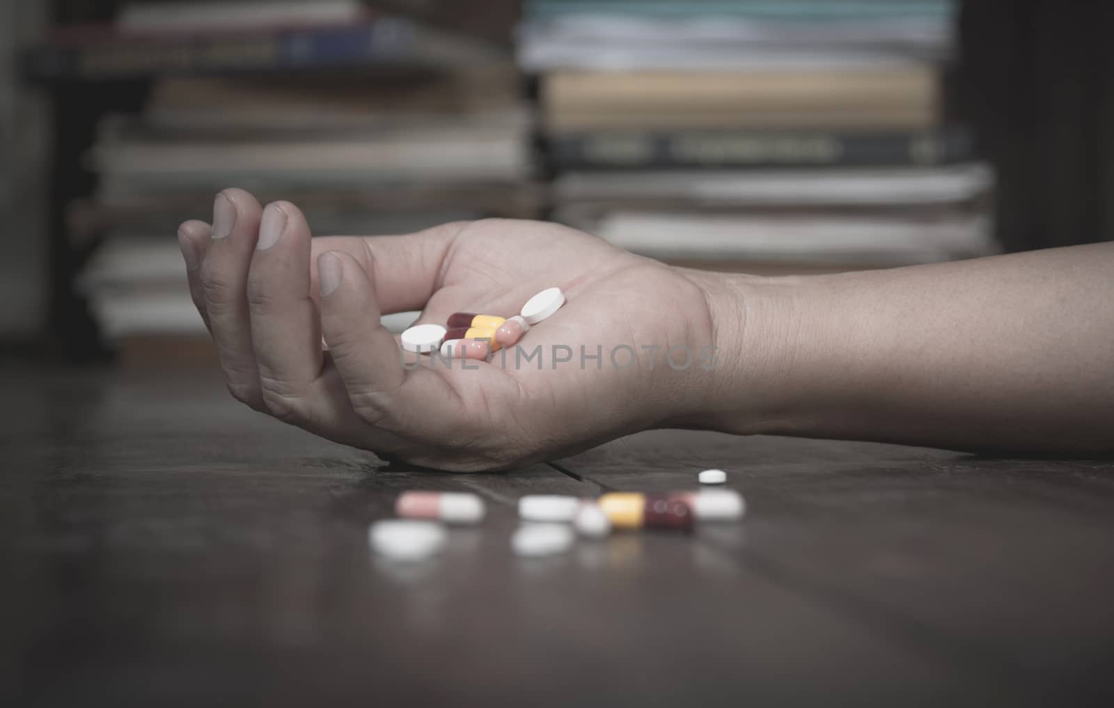 The man committing suicide by overdosing on medication. Close up of overdose pills and addict.