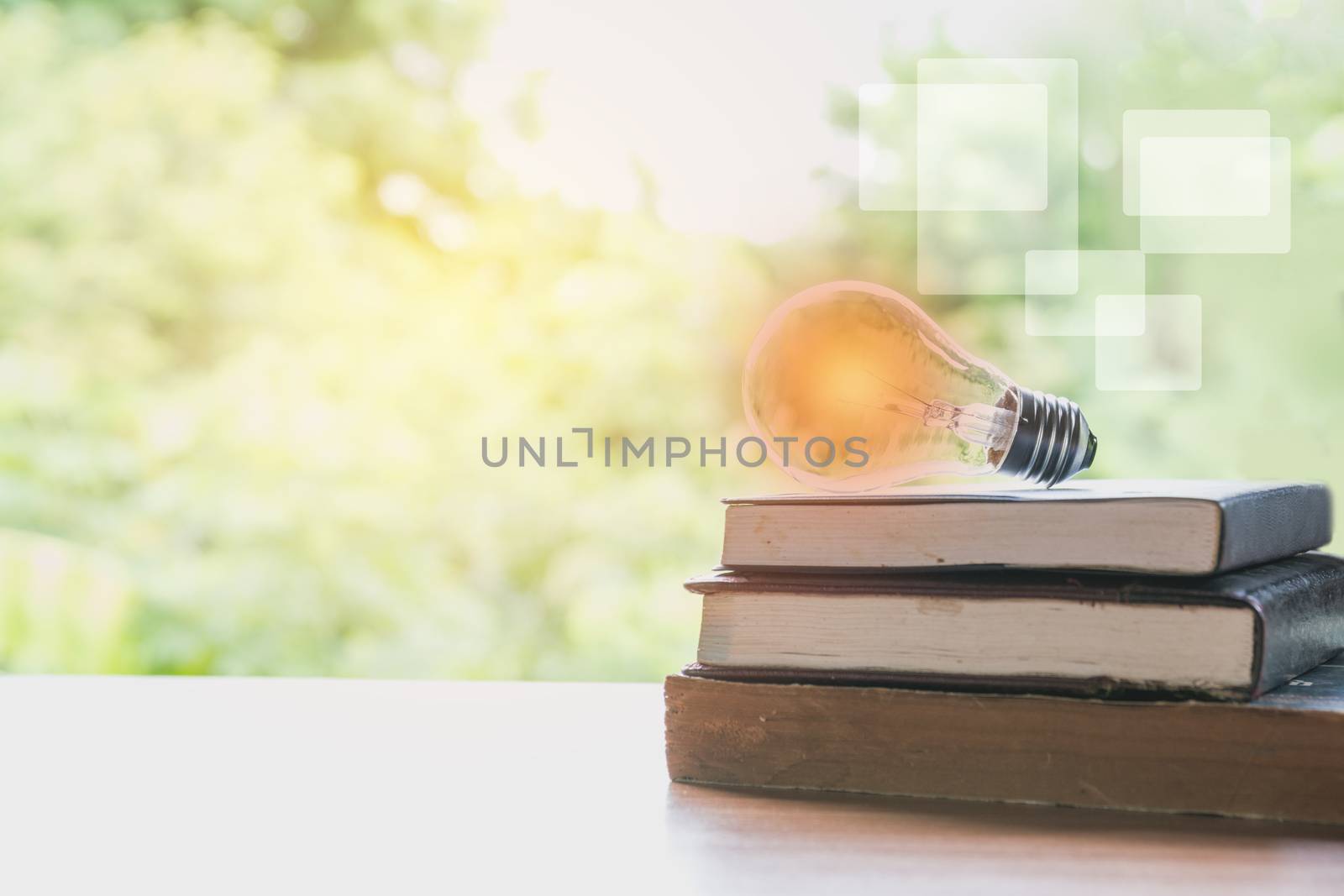 book and glowing light bulb over it. Knowledge and education concept.