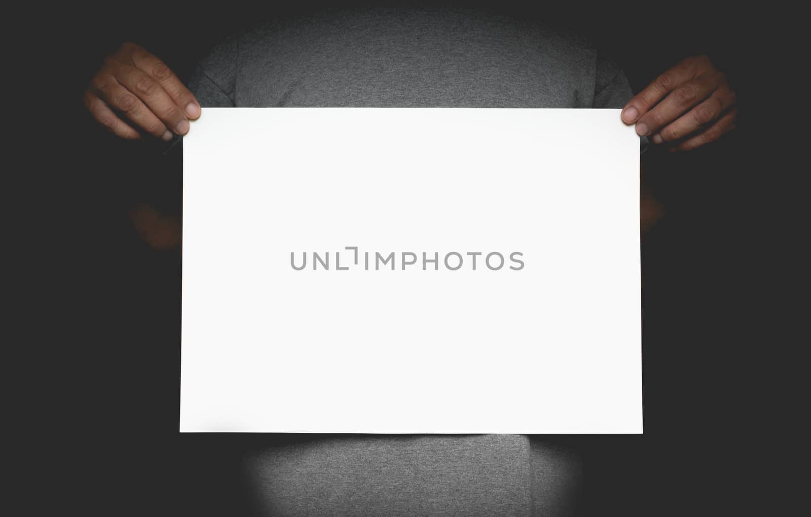 Human hands holding blank advertising card. Man showing and displaying placard ready for text mock-up. 