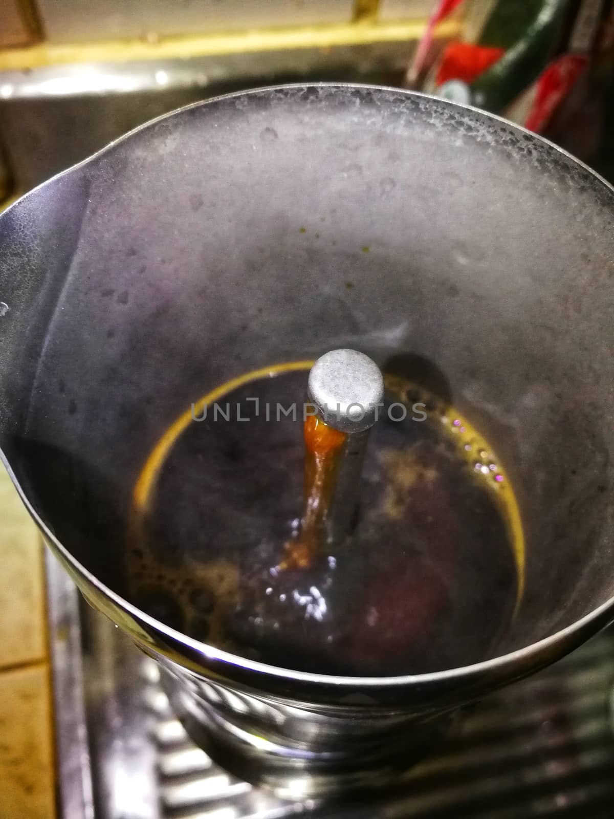 water of a coffee boiling in a coffee pot by shatchaya