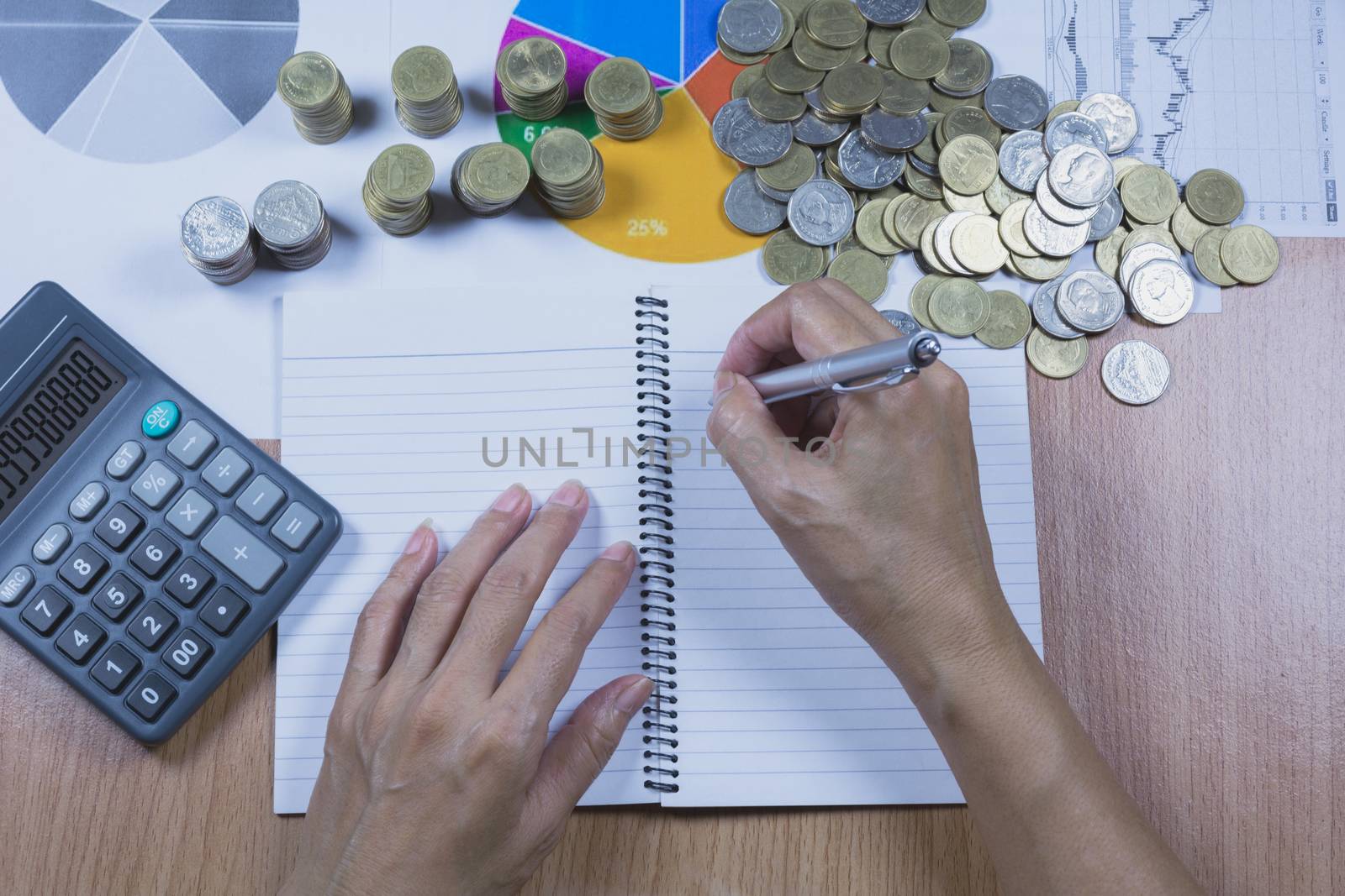 Businessman process with stack coins. Businessman working the project on table.