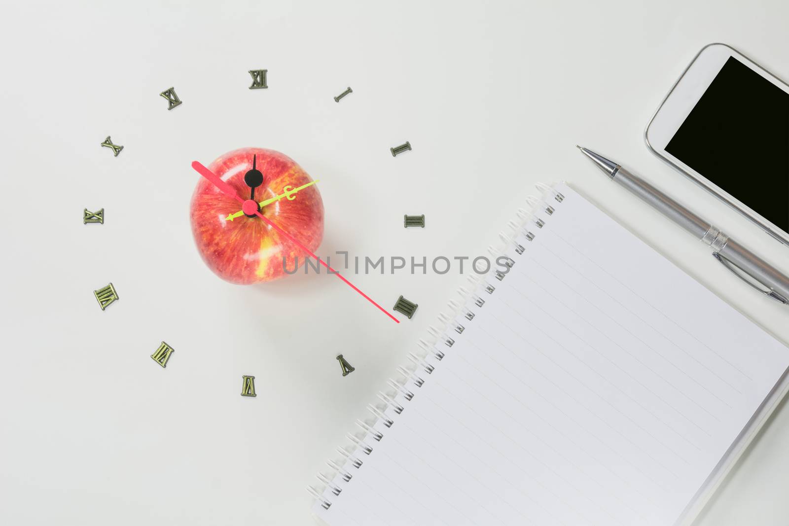 The apple with number of clock and smart phone, apple shape clock on white background. 