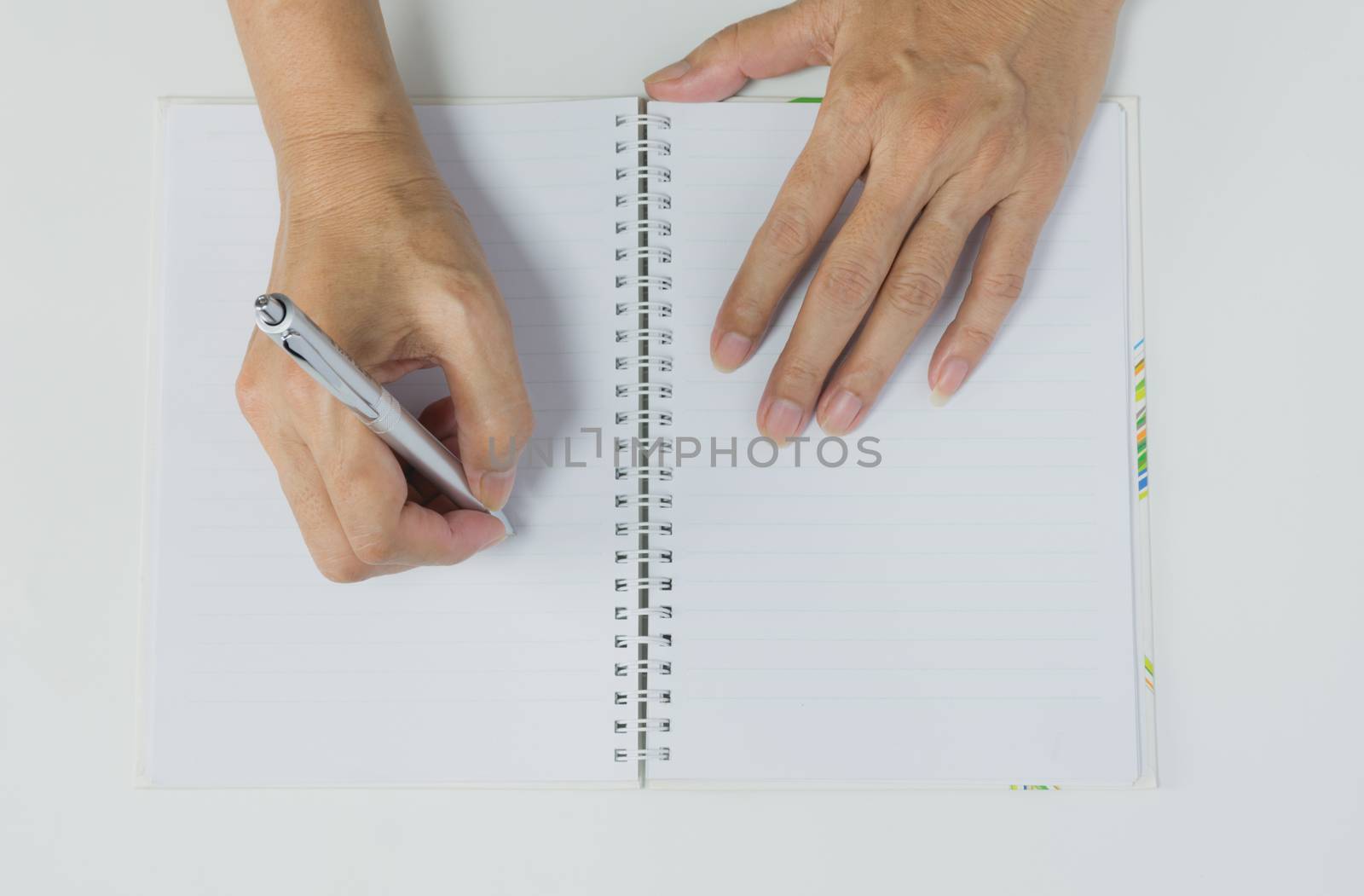 Close up hand writing on book paper with pen. Close up people writing on paper.