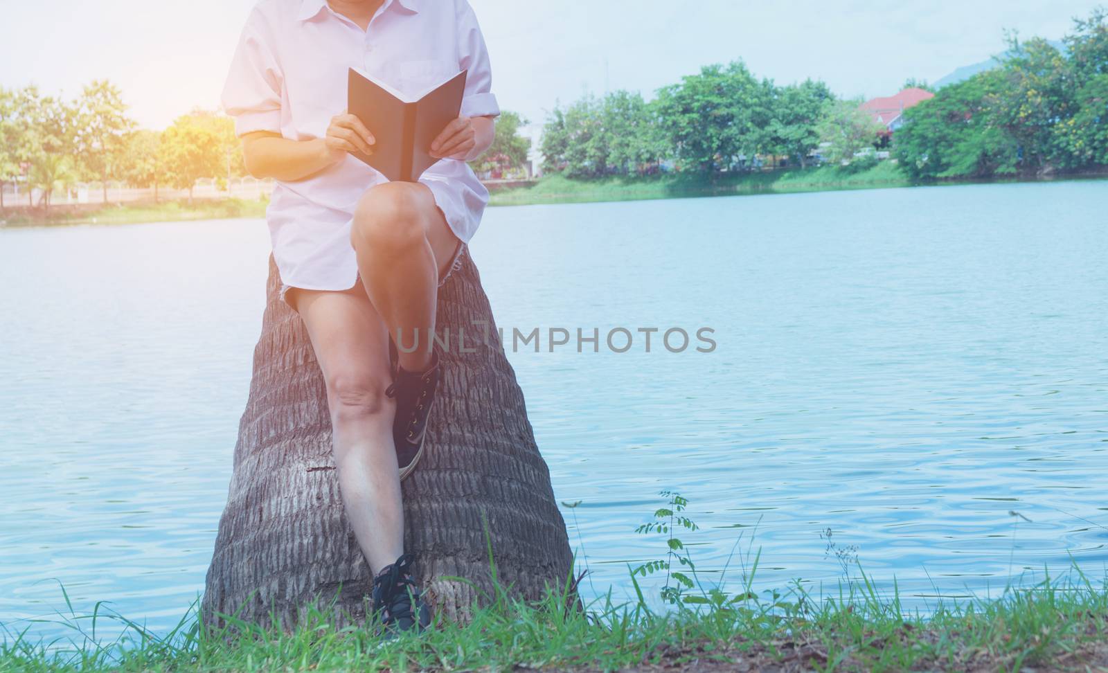 woman reading a book enjoys of rest. Woman hand holding a book for read. Concepts of rest and comfort.