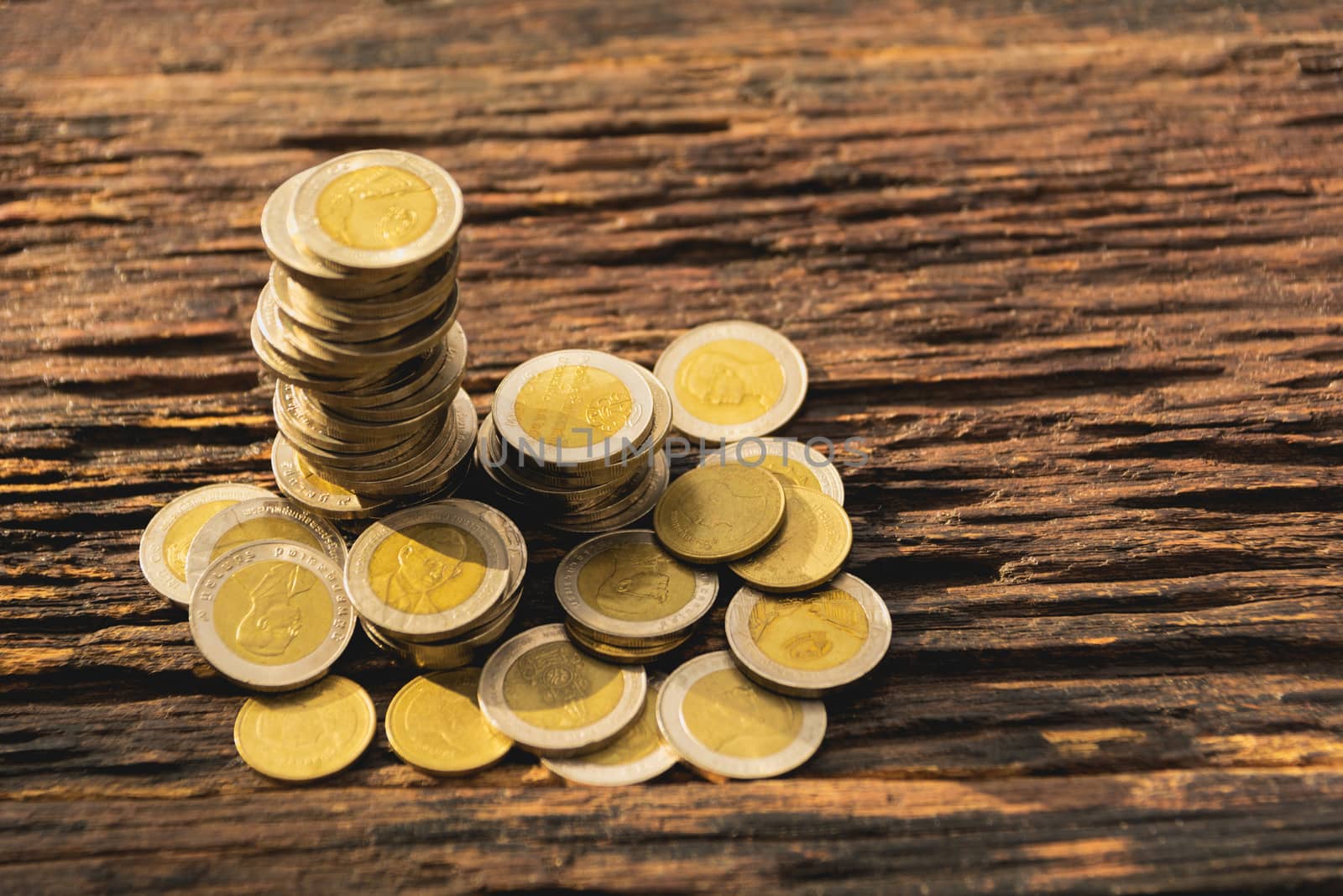 Closeup stack coin on wooden table. Financial and saving concept.