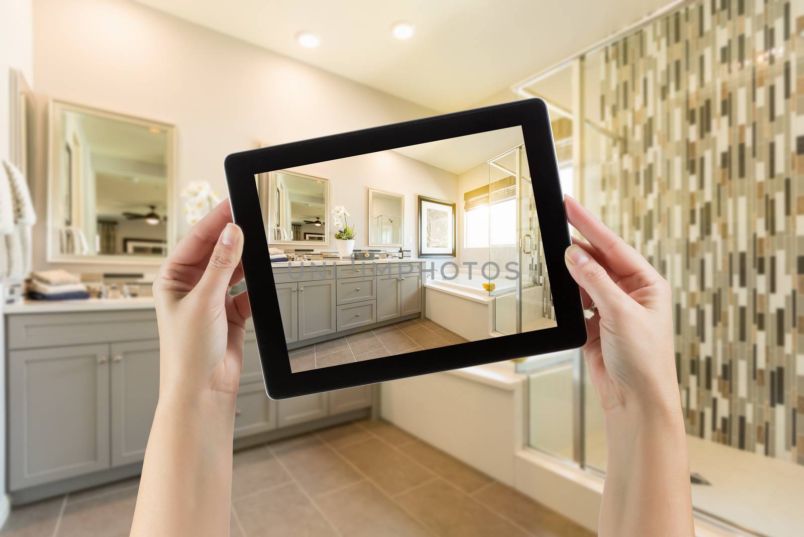 Master Bathroom Interior and Hands Holding Computer Tablet with Photo on Screen.