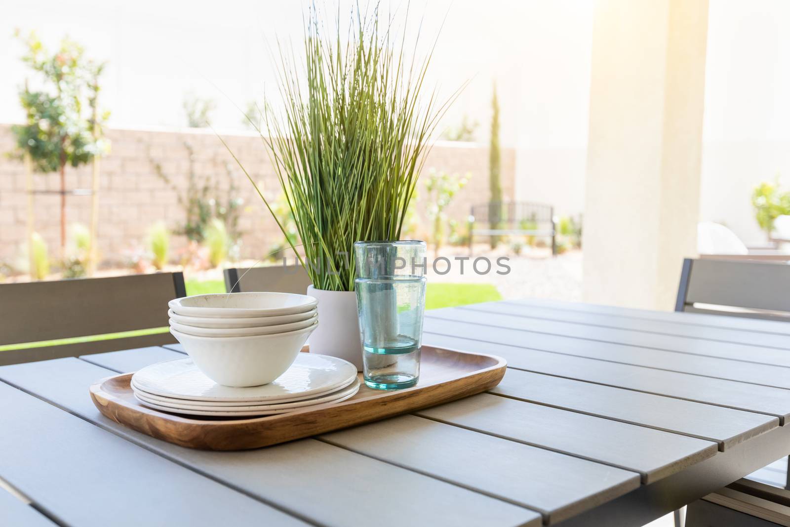 Outdoor Patio Setting with Dishes and Glasses on Tray.