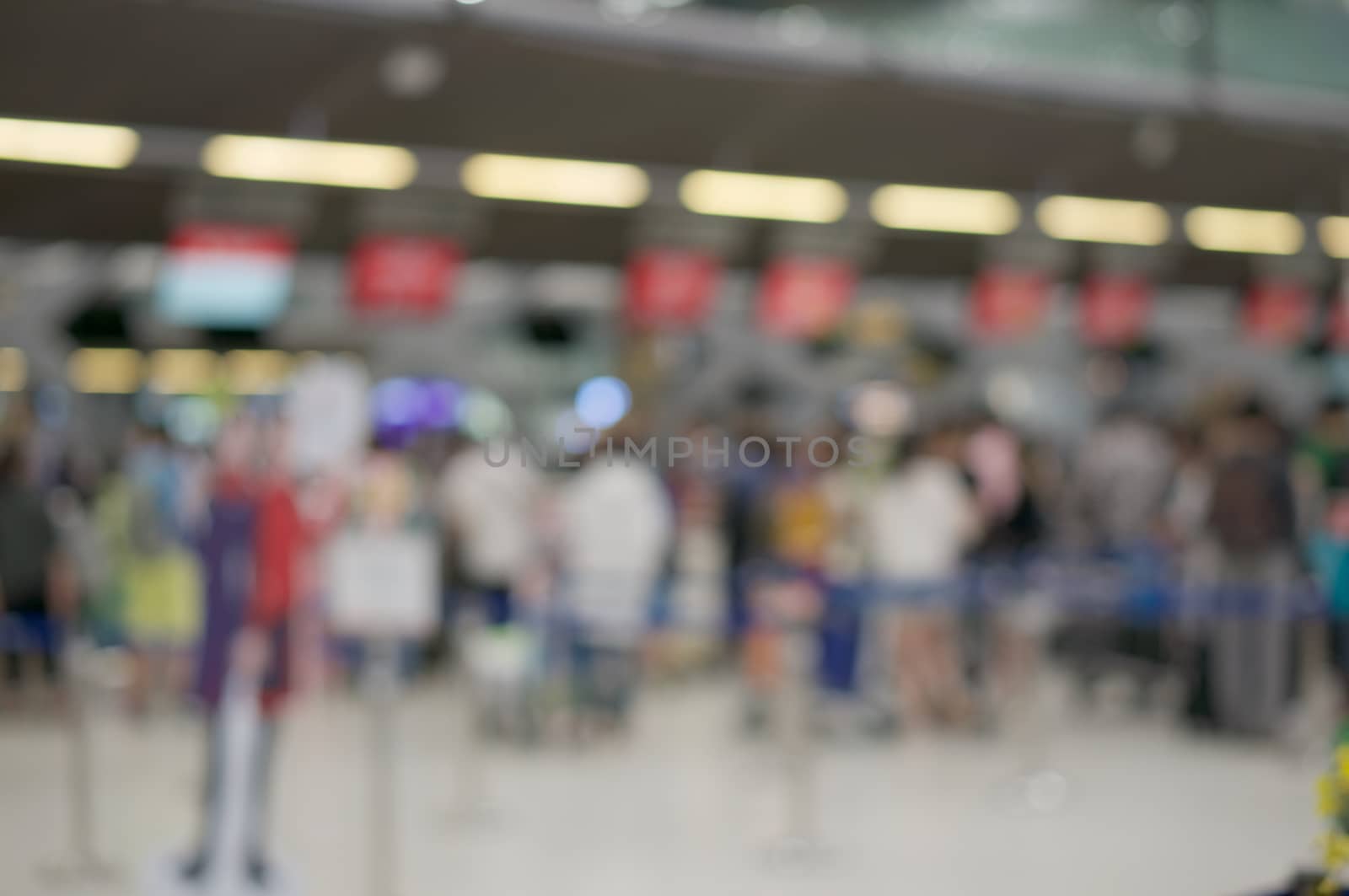 Abstract blurred passenger with suitcase waiting for check in at airport terminal. Business tourism and rush concept photography.